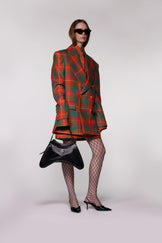 Model wearing the Helen Anthony Heritage Check Tailored Wool Short Skirt styled with the matching Heritage Check Double-Breasted Wool Blazer and small black leather shoulder bag for a modern luxury tailoring look.