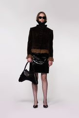 Model wearing the Helen Anthony Velvet Frill Cropped Jacket styled with the Organza Shirt, PU Leather Midi Skirt and small black leather shoulder bag for an elegant contemporary occasion look.