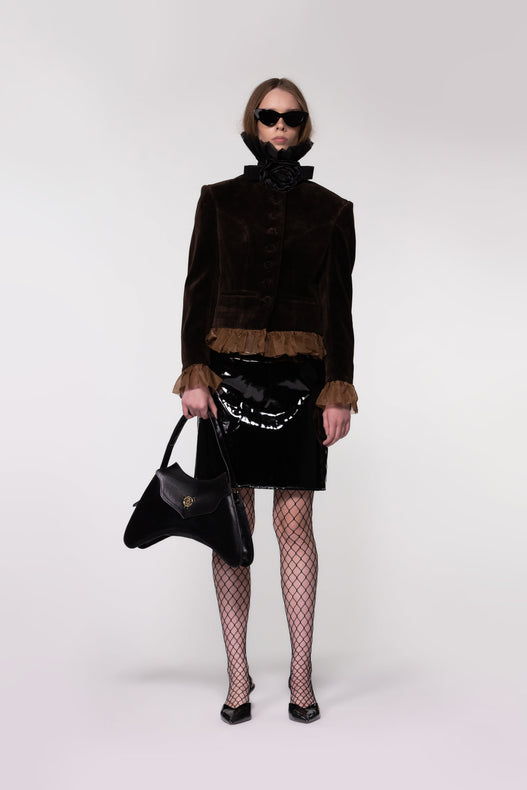 Model wearing the Helen Anthony Velvet Frill Cropped Jacket styled with the Organza Shirt, PU Leather Midi Skirt and small black leather shoulder bag for an elegant contemporary occasion look.