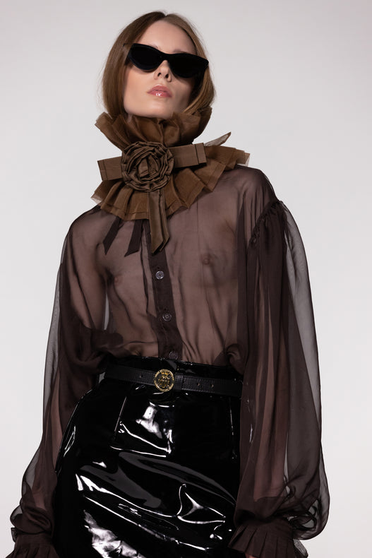 Model wearing the Helen Anthony black organza neck frill with detachable satin flower tie, styled with a sheer brown silk organza shirt 